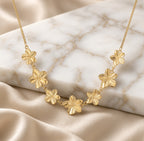 Collier fleurs dorées en acier inoxydable à sept motifs floraux